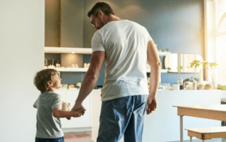 Man holding hand of small boy