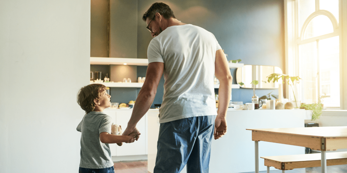 Man holding hand of small boy